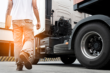 a truck driver walking towards a truck